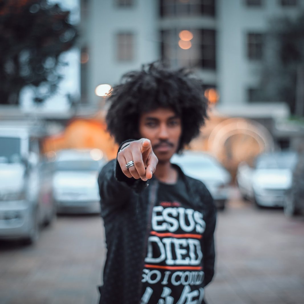 man pointing finger in front of camera